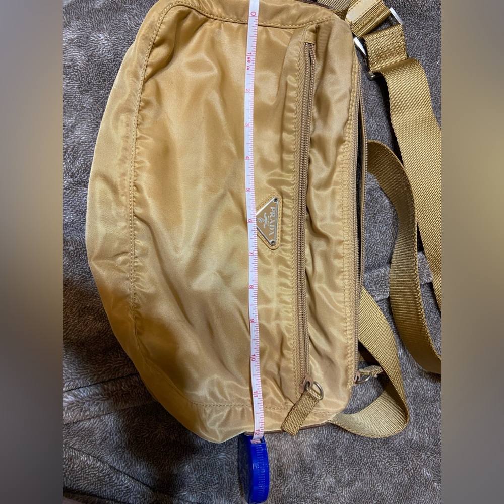 Prada small crossbody like a beige gold. Good condition. Inside liner is torn.
